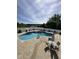 Backyard pool with a brick surround, privacy fence, and outdoor dining area at 4600 Scottland Dr, Mebane, NC 27302