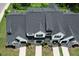 An aerial view of townhomes, showing grey shingled roofs, garages, driveways, and manicured landscaping at 727 Putney Hill Rd, Zebulon, NC 27597