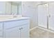 Bathroom featuring a modern vanity with a vessel sink and a walk-in shower with glass doors at 727 Putney Hill Rd, Zebulon, NC 27597