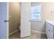 Bathroom featuring a door to the toilet room, a window and vanity with sink at 727 Putney Hill Rd, Zebulon, NC 27597