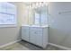 Bathroom featuring a double sink vanity, ample lighting, and a large mirror over tile floor at 727 Putney Hill Rd, Zebulon, NC 27597