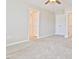 Carpeted bedroom featuring neutral walls and a ceiling fan, with doorways leading to other rooms at 727 Putney Hill Rd, Zebulon, NC 27597