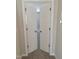 Open double doors reveal a carpeted bedroom, inviting and airy, featuring neutral decor at 727 Putney Hill Rd, Zebulon, NC 27597