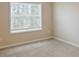 Well-lit bedroom featuring plush carpet, a large window, and neutral wall colors for a calming space at 727 Putney Hill Rd, Zebulon, NC 27597
