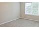 Cozy bedroom with carpet and a large window offering natural light and outdoor views at 727 Putney Hill Rd, Zebulon, NC 27597