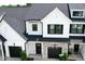 Exterior of a two-story townhome with black garage door and stone accents at 727 Putney Hill Rd, Zebulon, NC 27597