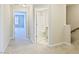 Hallway with neutral walls and plush carpet leads to a bathroom and bedroom space at 727 Putney Hill Rd, Zebulon, NC 27597