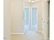 Hallway featuring neutral carpet and fresh paint leading to bedrooms with natural light at 727 Putney Hill Rd, Zebulon, NC 27597