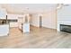Inviting living room with fireplace that seamlessly connects with a bright and modern kitchen at 727 Putney Hill Rd, Zebulon, NC 27597