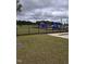 Community playground with slides and a black metal safety fence at 727 Putney Hill Rd, Zebulon, NC 27597