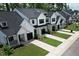 Street view of newly built townhomes with black trim, dark roofs, and green lawns at 727 Putney Hill Rd, Zebulon, NC 27597