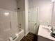 Bright bathroom with white shower, tub combo, vanity, and flooring at 215 Britt St, Smithfield, NC 27577
