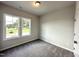 Sun-filled carpeted bedroom with bright windows and closet at 215 Britt St, Smithfield, NC 27577