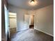 A spacious carpeted bedroom with two doors and neutral paint ready for new owners at 215 Britt St, Smithfield, NC 27577