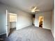 Spacious bedroom with neutral colors, plush carpet, ceiling fan, and closet at 215 Britt St, Smithfield, NC 27577