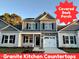 Two-story house with gray siding, stone accents, and a covered porch at 215 Britt St, Smithfield, NC 27577