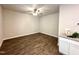 Living room area with ceiling fan, hardwood floors, and room for decor at 215 Britt St, Smithfield, NC 27577