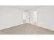 An empty bedroom showcases neutral walls and carpet, with doorways to other rooms at 490 Oak Park Blvd, Youngsville, NC 27596