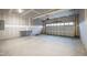 Spacious unfinished two-car garage featuring concrete floor and bright lighting at 490 Oak Park Blvd, Youngsville, NC 27596