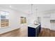 Bright kitchen features a stylish blue island, stainless steel appliances, and modern pendant lighting at 490 Oak Park Blvd, Youngsville, NC 27596