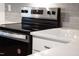 Stainless steel electric oven with white quartz countertop and modern gray tile backsplash at 490 Oak Park Blvd, Youngsville, NC 27596