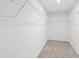 Carpeted walk-in closet features ample storage with wire shelving throughout at 490 Oak Park Blvd, Youngsville, NC 27596