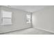 A carpeted bedroom features multiple windows providing great natural light at 1304 Jasmine View Way, Knightdale, NC 27545