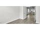 Bedroom with hardwood floors, light gray walls, and open french doors leading to kitchen at 1304 Jasmine View Way, Knightdale, NC 27545