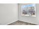 Bright bedroom with a view of the neighborhood, featuring hardwood floors and light gray walls at 1304 Jasmine View Way, Knightdale, NC 27545