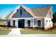 Exterior view of the clubhouse with board and batten siding and stone accents at 1304 Jasmine View Way, Knightdale, NC 27545