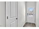 Welcoming entryway with a sturdy wooden door, modern lock, and light gray walls at 1304 Jasmine View Way, Knightdale, NC 27545