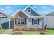 Charming exterior with blue siding, brick accents, and a well-manicured lawn at 1304 Jasmine View Way, Knightdale, NC 27545