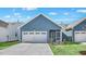 New construction featuring a two-car garage, charming blue siding and a well-manicured lawn at 1304 Jasmine View Way, Knightdale, NC 27545