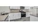 Modern kitchen features stainless steel appliances, grey backsplash, and ample counter space at 1304 Jasmine View Way, Knightdale, NC 27545