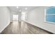 Modern living room with hardwood floors, light gray walls, and plenty of natural light at 1304 Jasmine View Way, Knightdale, NC 27545