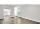 Open-concept living room with hardwood floors, light gray walls, and large windows at 1304 Jasmine View Way, Knightdale, NC 27545