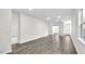 Large living room featuring hardwood floors, light gray walls, recessed lighting, and neutral color scheme at 1304 Jasmine View Way, Knightdale, NC 27545