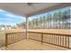 Covered back porch featuring a wood floor and a view of the large backyard at 80 Bold Dr, Youngsville, NC 27596