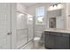 Clean bathroom with a tiled shower, vanity, and a window allowing natural light at 80 Bold Dr, Youngsville, NC 27596