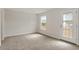 Bedroom featuring soft carpet, a door to the outside, and a sunlit window at 80 Bold Dr, Youngsville, NC 27596