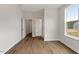 Bright bedroom with wood flooring and a large window showing the outside view at 80 Bold Dr, Youngsville, NC 27596