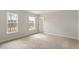 Carpeted bedroom featuring two large windows and neutral walls at 80 Bold Dr, Youngsville, NC 27596