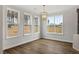 Open dining area with wood floors and ample natural light from large windows at 80 Bold Dr, Youngsville, NC 27596