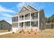 Beautiful two-story home featuring a covered balcony, attached garage, and landscaped front yard at 80 Bold Dr, Youngsville, NC 27596