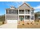 Charming two-story home with a covered porch, attached garage, and neutral color palette at 80 Bold Dr, Youngsville, NC 27596