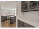 Modern kitchen with gray cabinets, quartz countertops, and stainless steel appliances at 80 Bold Dr, Youngsville, NC 27596