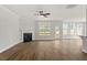 Spacious living room with a fireplace, wood floors, and access to the backyard deck at 80 Bold Dr, Youngsville, NC 27596