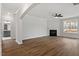 Open living room features a fireplace, ceiling fan, and wood-look flooring at 80 Bold Dr, Youngsville, NC 27596