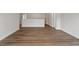 Spacious living room with wood flooring throughout and a view to the hallway and staircase at 80 Bold Dr, Youngsville, NC 27596