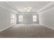 Spacious main bedroom with tray ceiling, fan, and abundant natural light at 80 Bold Dr, Youngsville, NC 27596